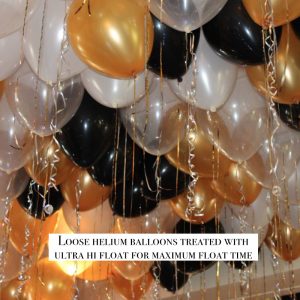 Loose helium balloons gold black white